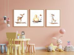 three framed pictures hang on the wall in a child's room with toys and decor