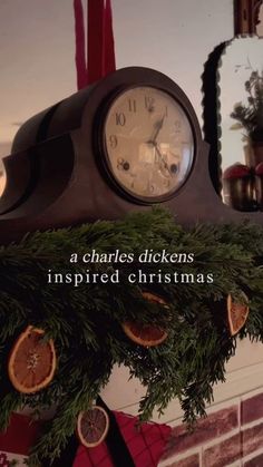 a clock that is sitting on top of a mantle in front of a fireplace with christmas decorations