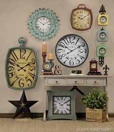 a bunch of clocks are hanging on the wall