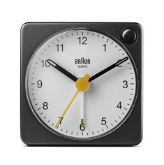 a black and white clock with yellow hands on it's face, showing the time