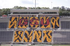 an empty football stadium filled with yellow and red letters