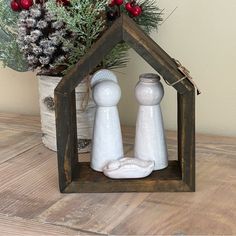 a small wooden house with two salt and pepper shakers