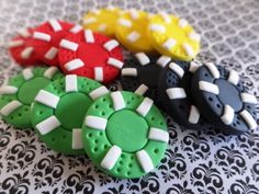 four decorated cookies sitting on top of a black and white tablecloth covered table cloth