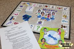 a board game with pieces of paper on the floor next to it and an envelope