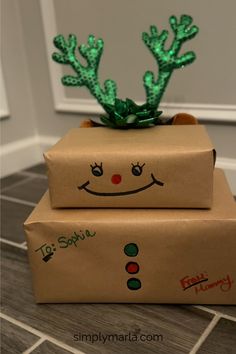 two boxes are decorated like reindeer heads and have green lights on their head, sitting on top of each other