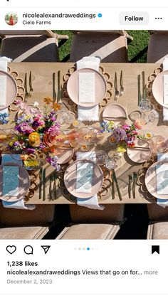 the table is set with flowers and plates