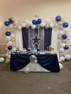 the table is set up with balloons and decorations