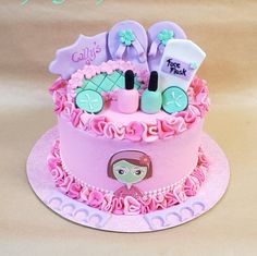 there is a pink cake decorated with baby items