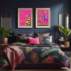 two paintings hang above a bed in a room with dark blue walls and pink accents