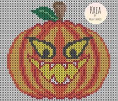 a cross stitch pattern of a pumpkin with an evil face on it's side