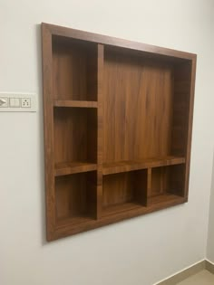 a wooden shelf mounted on the wall