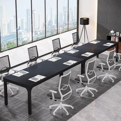 an empty conference room with black and white chairs