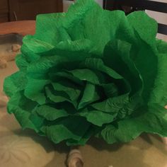 a large green flower sitting on top of a table