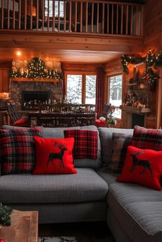 a living room filled with furniture covered in christmas pillows and decor on top of it