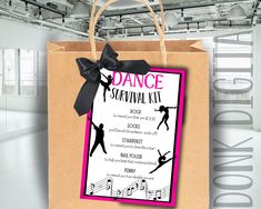 the dance survival kit is in a brown paper bag with a black bow on it