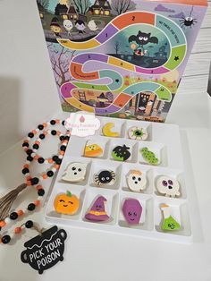 an assortment of halloween themed cookies and candy on a table with a trick - or - treat card