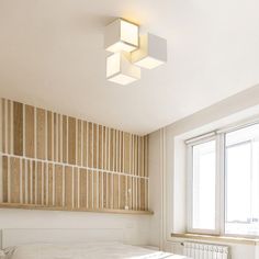 a bed room with a neatly made bed and wooden paneling on the headboard