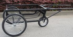 a black cart with two wheels on the street