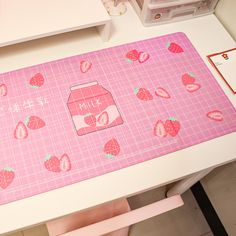 a pink place mat with strawberries on it