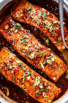 salmon with sesame seeds and seasoning in a pan