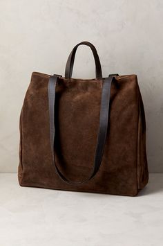 Luxury meets utility in the sophisticated Sutton tote, crafted from genuine waterproof Italian suede leather. Featuring a roomy main compartment that can hold a 13-15" laptop, this rich calfskin suede bag also has a smaller zip compartment and open pocket inside. Carry it with the leather handles or by the shoulder straps—either way, the Sutton takes you where you need to go with all your essentials in tow. With magnetic snap closure, snaps along throat sides, and cotton lining throughout. Fox Fur Boots, Fluffy Boots, Suede Tote Bag, Suede Tote, Leather Bag Women, Fur Boots, Large Tote Bag, Women Leather, Large Tote