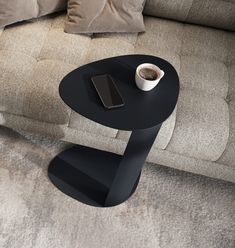 a coffee table with a phone on it next to a couch