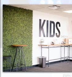 an office with two desks and a wall that says kids written on the side