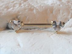 two gold tone nose piercings with clear crystal stones on each end, set against a white background