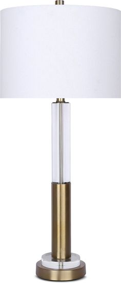 a table lamp with a white shade on it and a gold base is shown in front of a white background