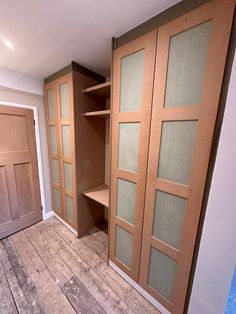 an empty room with wooden floors and closets