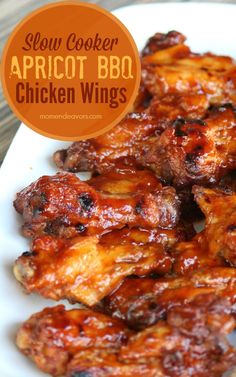 some chicken wings are on a white plate with an orange label over it that says slow cooker apricot bbq chicken wings