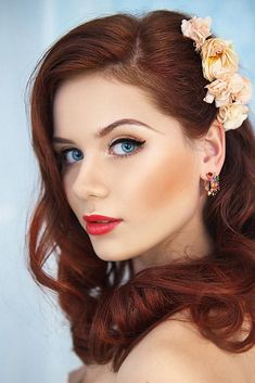 a woman with long red hair and flowers in her hair