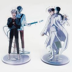 two figurines are standing next to each other in front of a white background