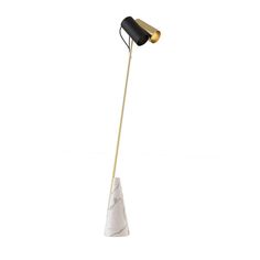 a marble and brass floor lamp with a black shade on the top, standing in front of a white background