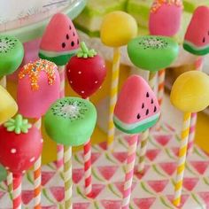 watermelon pops with sprinkles on them are sitting on a table