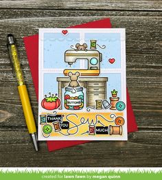 a card with a sewing machine on it next to a pen and paper crafting supplies