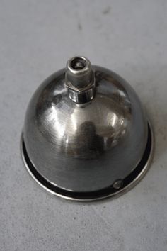 a metal object sitting on top of a white table