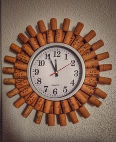 a clock made out of wine corks on the wall