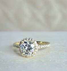 an engagement ring with a diamond center and pave set side stones on the band