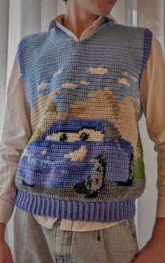 a man wearing a sweater with cars on it