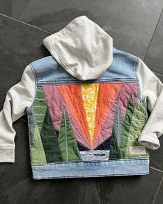 a jacket with an image of trees and mountains on it