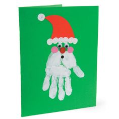 a handprinted christmas card with santa's hat and eyeballs on it