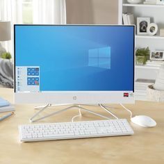 a desktop computer monitor sitting on top of a desk next to a keyboard and mouse