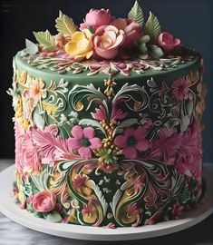 a colorful cake decorated with flowers and leaves