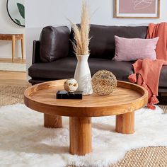 a living room with a couch, coffee table and other items on the rugs