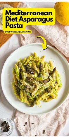 a white plate topped with pasta covered in pesto