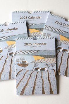 five calendars with trees and houses on them