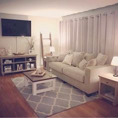 a living room filled with furniture and a flat screen tv