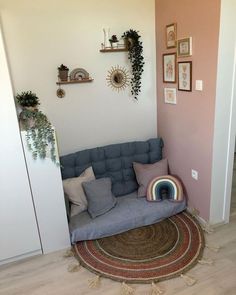 a living room with a couch and rugs on the floor in front of it