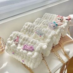 a white purse sitting on top of a table